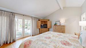 a bedroom with a bed and a large window at 20 Port Tack in Hilton Head Island +42 photos