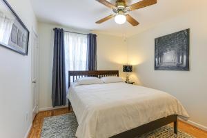a bedroom with a bed and a ceiling fan at 13 Mi to Downtown Baltimore Quiet Home with Porch in Middle River