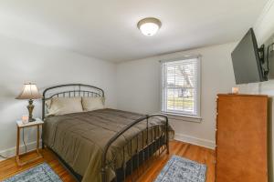 a bedroom with a bed and a flat screen tv at 2 Mi to SUNY Cortland Home Near Hiking and Golf! in Cortland