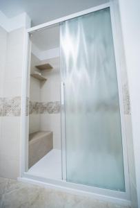 a shower with a glass door in a bathroom at Il Galante B&B casa vacanza in Ginosa