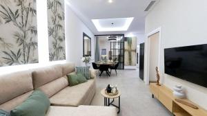 a living room with a couch and a large tv at Apartamento Marea in Castell de Ferro +91 photos