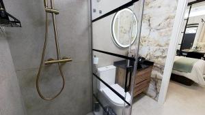 a bathroom with a shower and a sink and a mirror at Apartamento Marea in Castell de Ferro