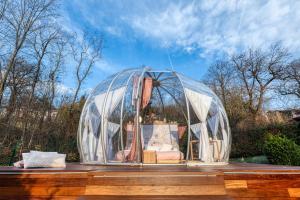 a glass dome with a bed in it on a table at Il Cantico Bubble Room Experience in San Giacomo