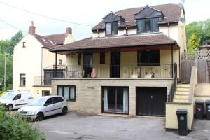 a house with a car parked in front of it at The Hanham Retreat in Bristol