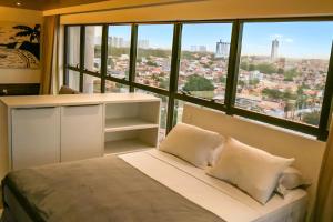 Cama ou camas em um quarto em Reserva Madero Loft Natal Hotel