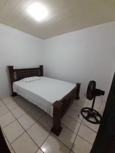a bedroom with a bed and a camera on the floor at Apartamentos GoZu # 2 in Puerto Viejo