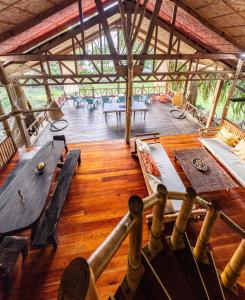 a large room with wooden floors and tables and benches at Dadatan Getaway in Magamomo