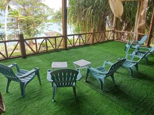 a group of chairs and a table on a lawn at Dadatan Getaway in Magamomo +1 photo