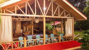 a pavilion with chairs and a table and a dining room at Dadatan Getaway in Magamomo