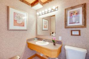 a bathroom with a sink and a toilet and a mirror at Spacious Yellowstone River Retreat with Trails! in Emigrant +27 photos