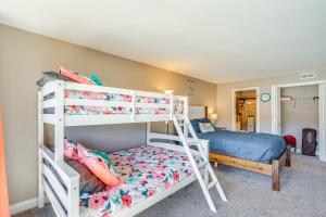 a bedroom with two bunk beds and a bed at Boat Slip and Pools Lakefront Osage Beach Condo in Osage Beach +37 photos