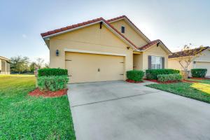a house with a garage in a yard at 7 Mi to USTA Waterfront Tennis House with Yard! in Kissimmee