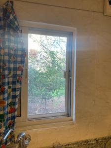 a window over a sink in a kitchen at شقه مفروشه in Khinzīrah +1 photo