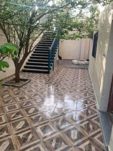 a hallway with a staircase and a tile floor at شقه مفروشه in Khinzīrah