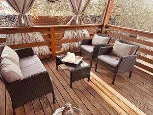 a porch with chairs and a table on a deck at Casabella Turanj in Turanj