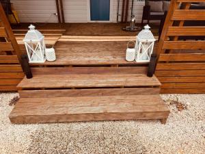 a wooden porch with three lights on it at Casabella Turanj in Turanj