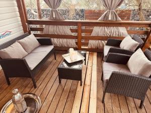 a porch with two chairs and a table on a deck at Casabella Turanj in Turanj