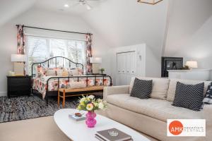 a living room with a couch and a bed at Downtown Douglas Coach House in Douglas +11 photos