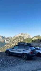 two cars parked on the side of a mountain at lodi campers rental in Theth +9 photos