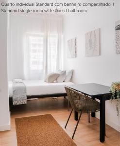 um quarto com uma cama com uma mesa e uma mesa sidx sidx em Soar Home I Urban Nest - Near Airport & Green Park em Lisboa