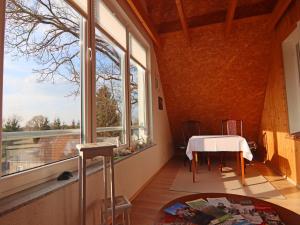 a room with a table and a large window at Gemütliche Ferienwohnung in Mallentin in Mallentin