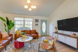 a living room with a large flat screen tv at Family Home with Furnished Deck in Fairview! in Fairview