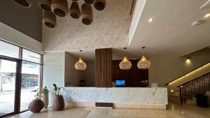 an office lobby with a reception desk and pendant lights at Hotel Caribbean by On vacation in San Andrés +15 photos