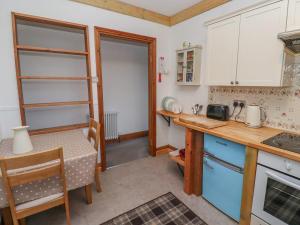 a kitchen with a table and a dining room at Seafield Granary in Alnwick +15 photos