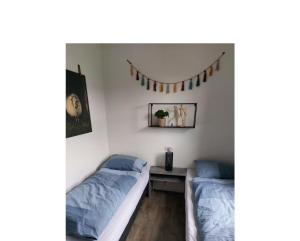 a bedroom with two beds and a table with a mirror at Enkhuizer Strand Chalet Enkhuizer Strandhuis Haus Nr 206 in Enkhuizen +8 photos