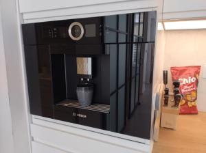 a microwave oven sitting on top of a wall at Beach House Rodine - free parking & bikes in Scheveningen +28 photos