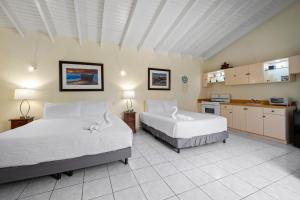 a bedroom with two beds and a kitchen at Sunny Paradise Villa in Noord +70 photos