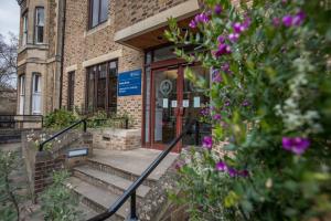 a building with purple flowers in front of it at Rewley House University of Oxford in Oxford