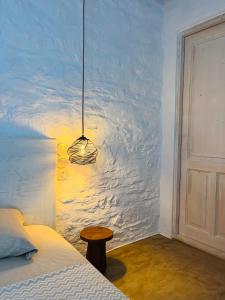 a bedroom with a bed and a table next to a door at Kythnian Retreat in Kithnos