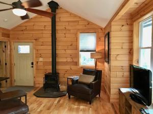 a living room with a fireplace in a log cabin at Elkhorn Rustic Blowing Rock Cabin Amazing Views in Bailey Camp