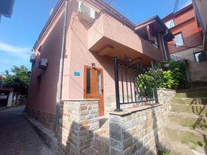 a pink house with a door and a fence at Mihalkat Old Town in Sozopol