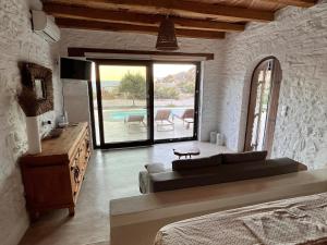 a bedroom with a couch and a table and a pool at Kythnian Retreat in Kithnos