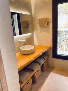 a bathroom with a sink on a wooden counter at Kythnian Retreat in Kithnos +30 photos