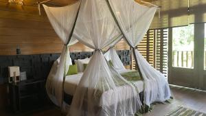 a bedroom with a bed with mosquito netting at Hotel Amazon by On Vacation in Leticia +46 photos