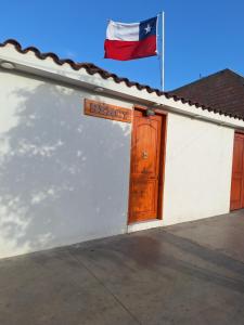 a flag on top of a white building with a flag at Bercy in Arica