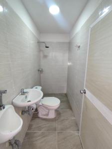 a bathroom with a toilet and a sink at CasaCabaña in Santa Marta
