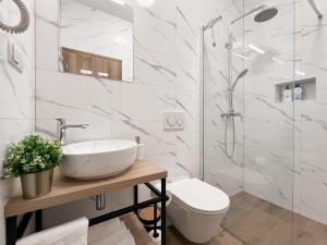 a bathroom with a sink and a toilet and a shower at Apartments BINGO - Zagreb airport in Velika Gorica +28 photos