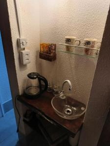 a bathroom with a sink and a coffee maker on a counter at Chalé Araras in Chapada dos Guimarães +28 photos