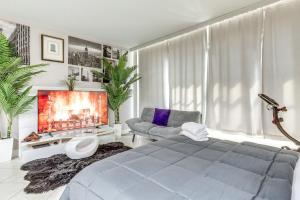a living room with a bed and a tv at Downtown Studio with City Views in Jacksonville! in Jacksonville