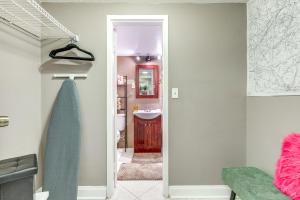 a bathroom with a door open to a bathroom with a sink at Downtown Studio with City Views in Jacksonville! in Jacksonville +16 photos