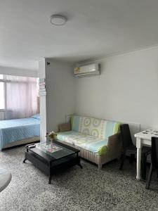 a living room with a couch and a table at Laguito Suites Cartagena in Cartagena de Indias +27 photos