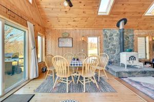 une salle à manger avec une table et des chaises et une cheminée dans l'établissement 3 Mi to Catskill Trail Stamford Cottage with Views, à Stamford