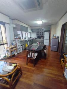 a large kitchen with a table in the middle of a room at Kanupata - Vacation STAY 18614 in Ishigaki Island