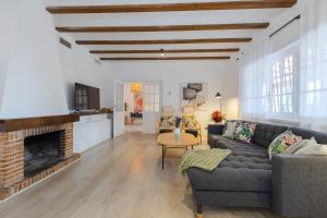 a living room with a couch and a fireplace at The Urban Mansion by Fidalsa in Alicante