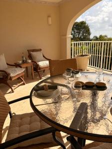 a table with glasses on it in a living room at Royal Apartments 1 bedroom apartment sea views in Saint James