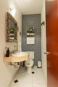 a bathroom with a white toilet and a sink at Downtown Villa for 7 guests, access to pool! in Cancún